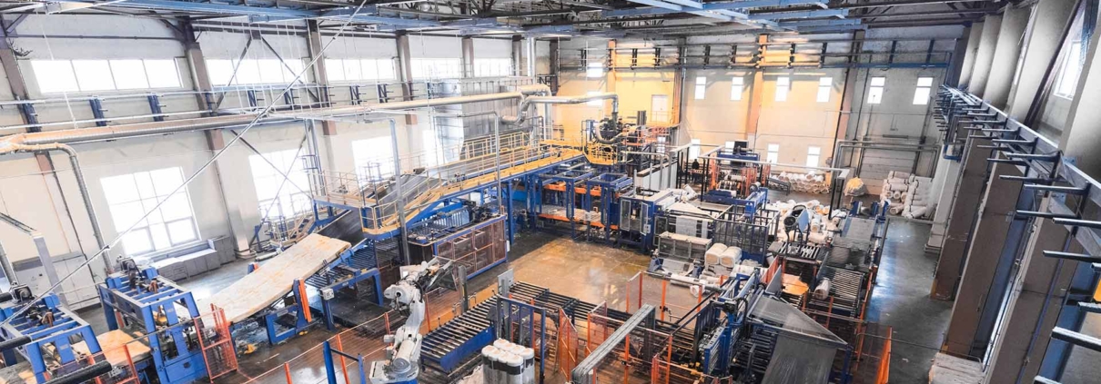 Planning Permits for Manufacturing & Processing Facilities - Picture of the inside of a factory with complex assembly line of machines.