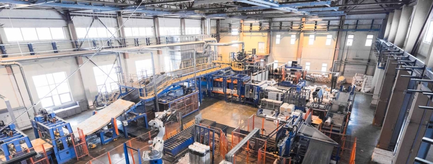 Planning Permits for Manufacturing & Processing Facilities - Picture of the inside of a factory with complex assembly line of machines.